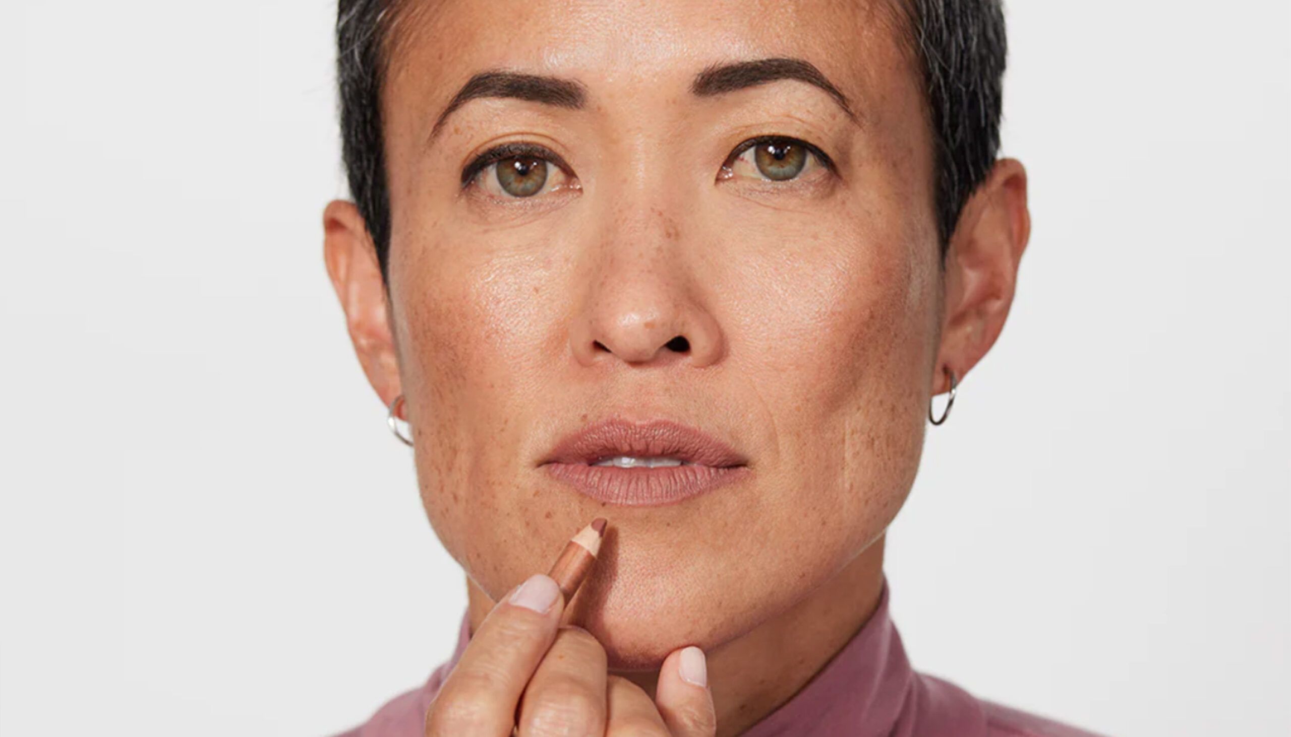 woman applying jones road lip liner