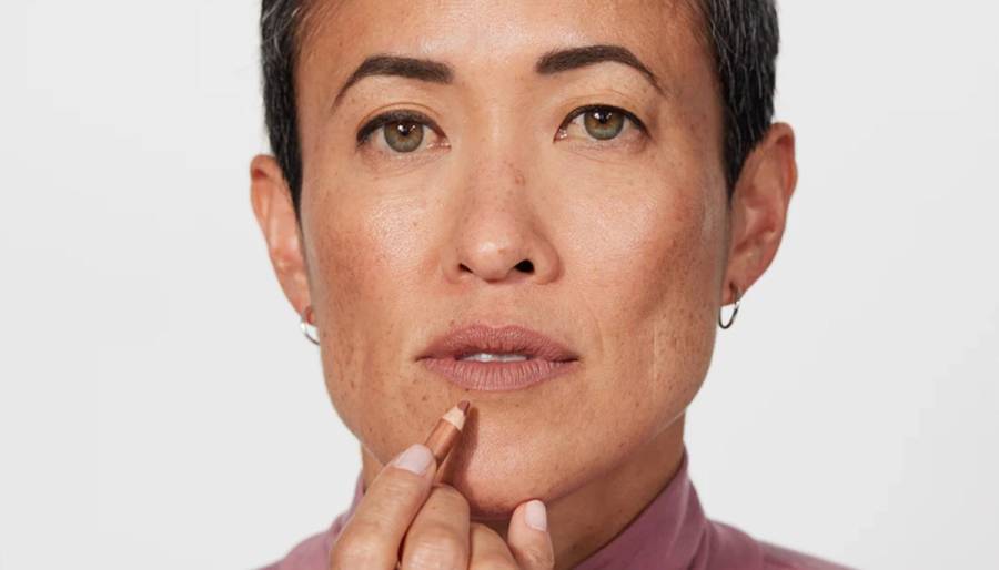 woman applying jones road lip liner