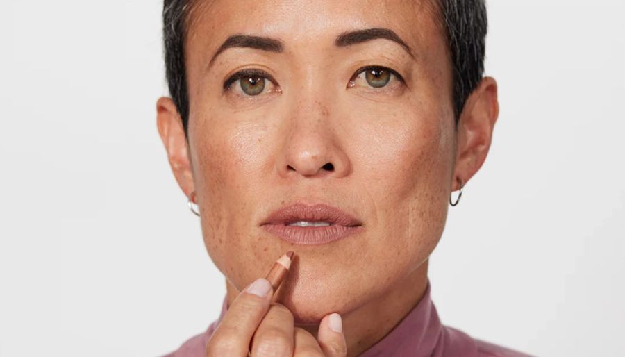 woman applying jones road lip liner