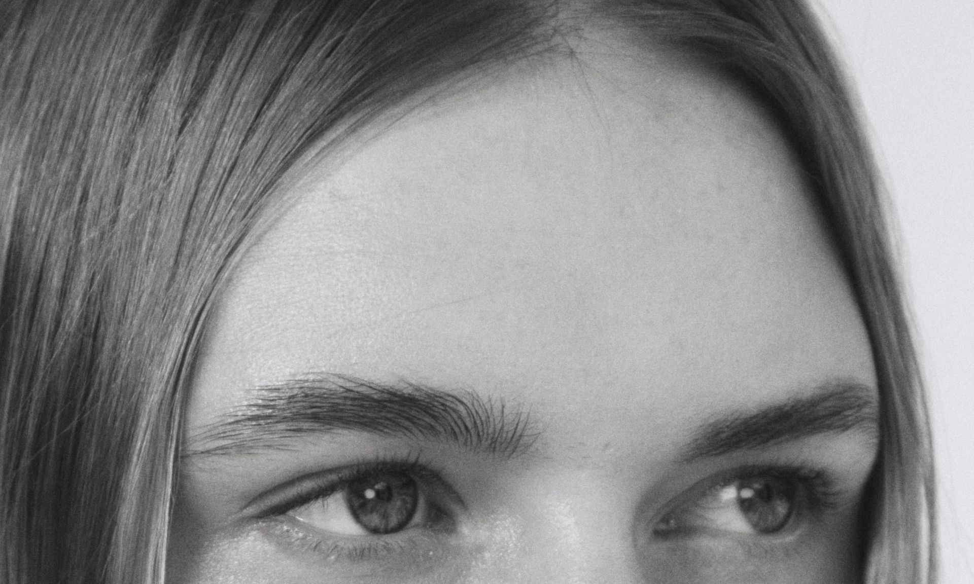 black and white photo of woman's forehead