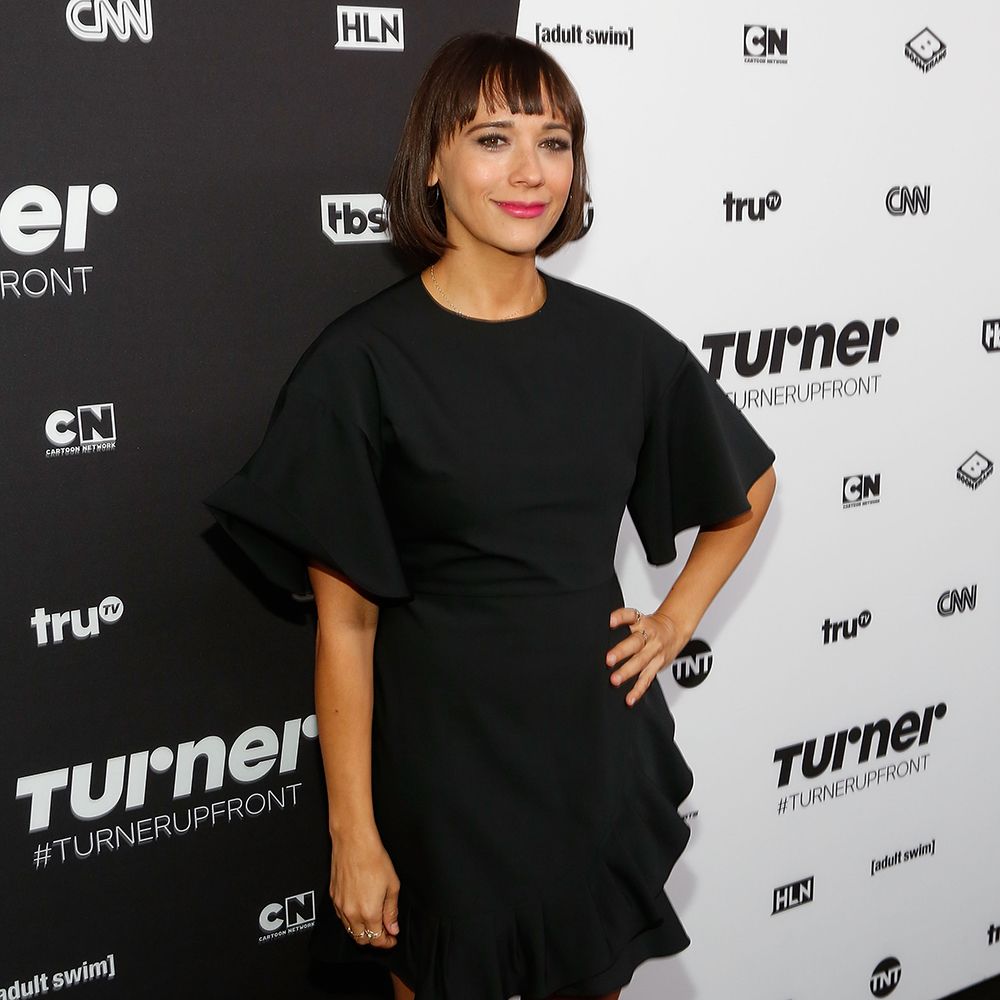 Rashida Jones with short hair and bangs in black puffy-sleeve dress