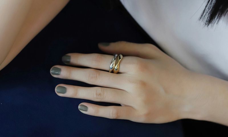 Close up of woman's hand with gray nail polish