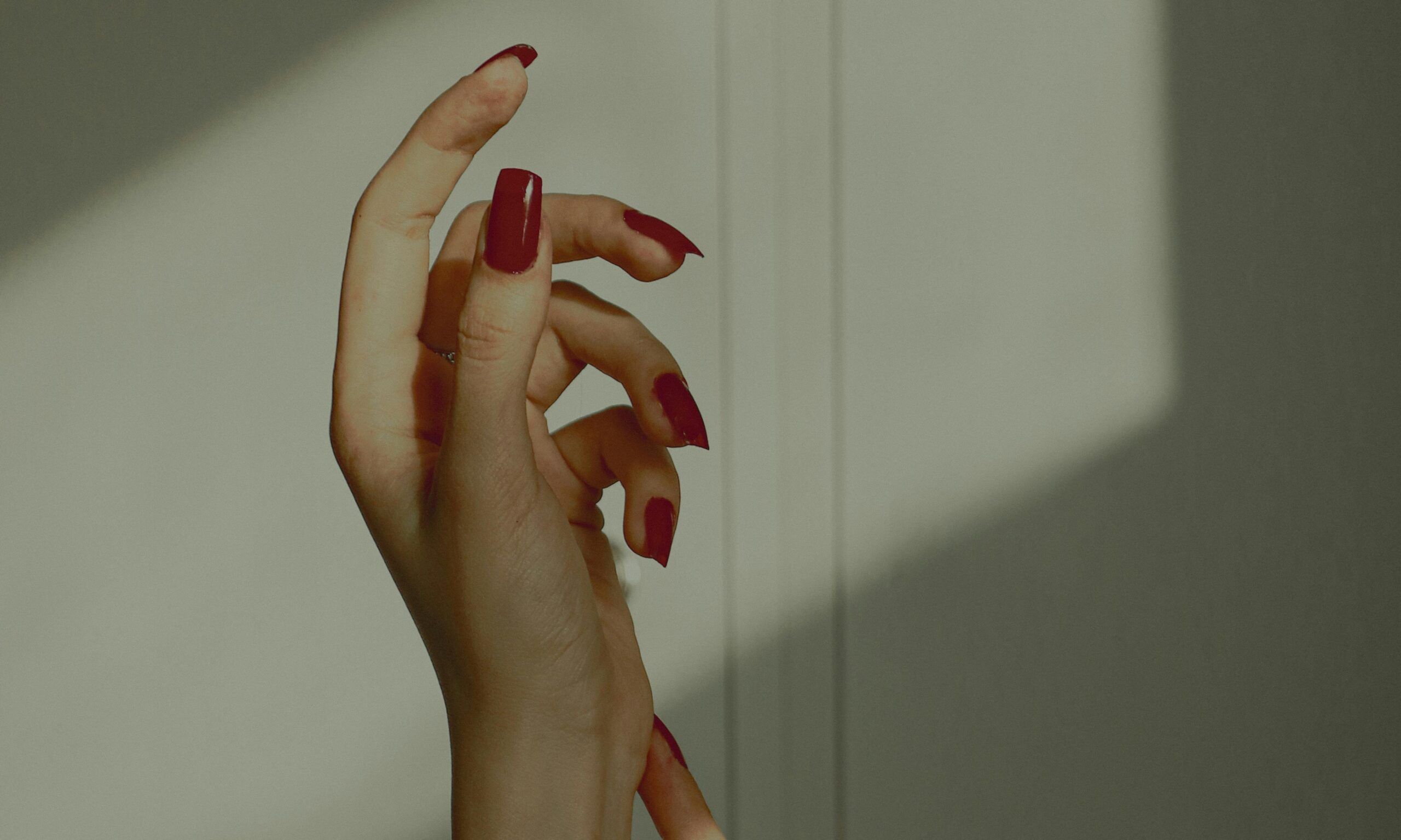 red nails against shadows