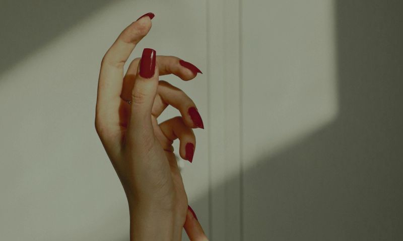 red nails against shadows