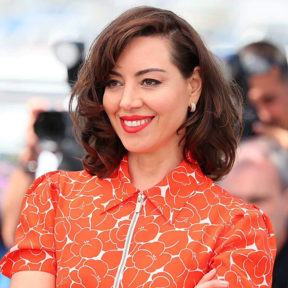 Aubrey Plaza in orange dress