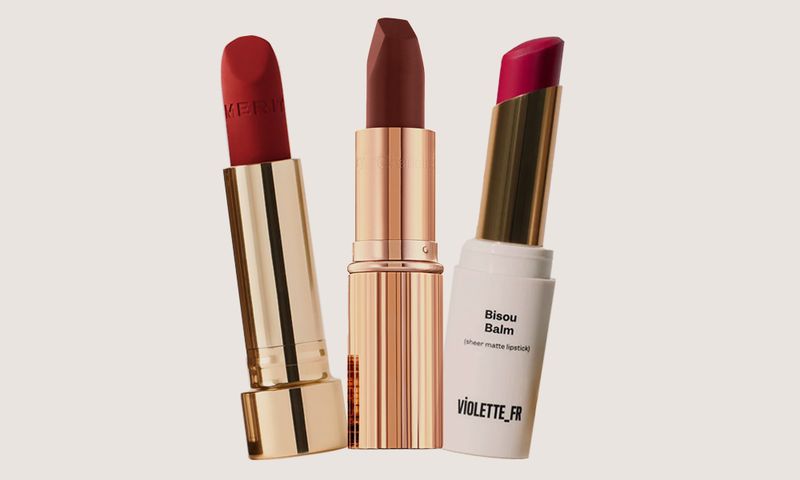various lipsticks on beige background