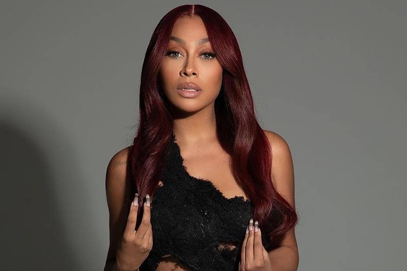 Lala Anthony on gray background