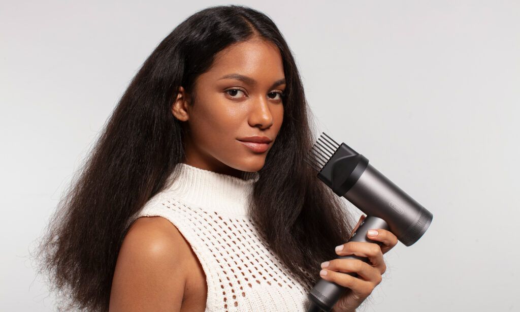 woman holding hair styler