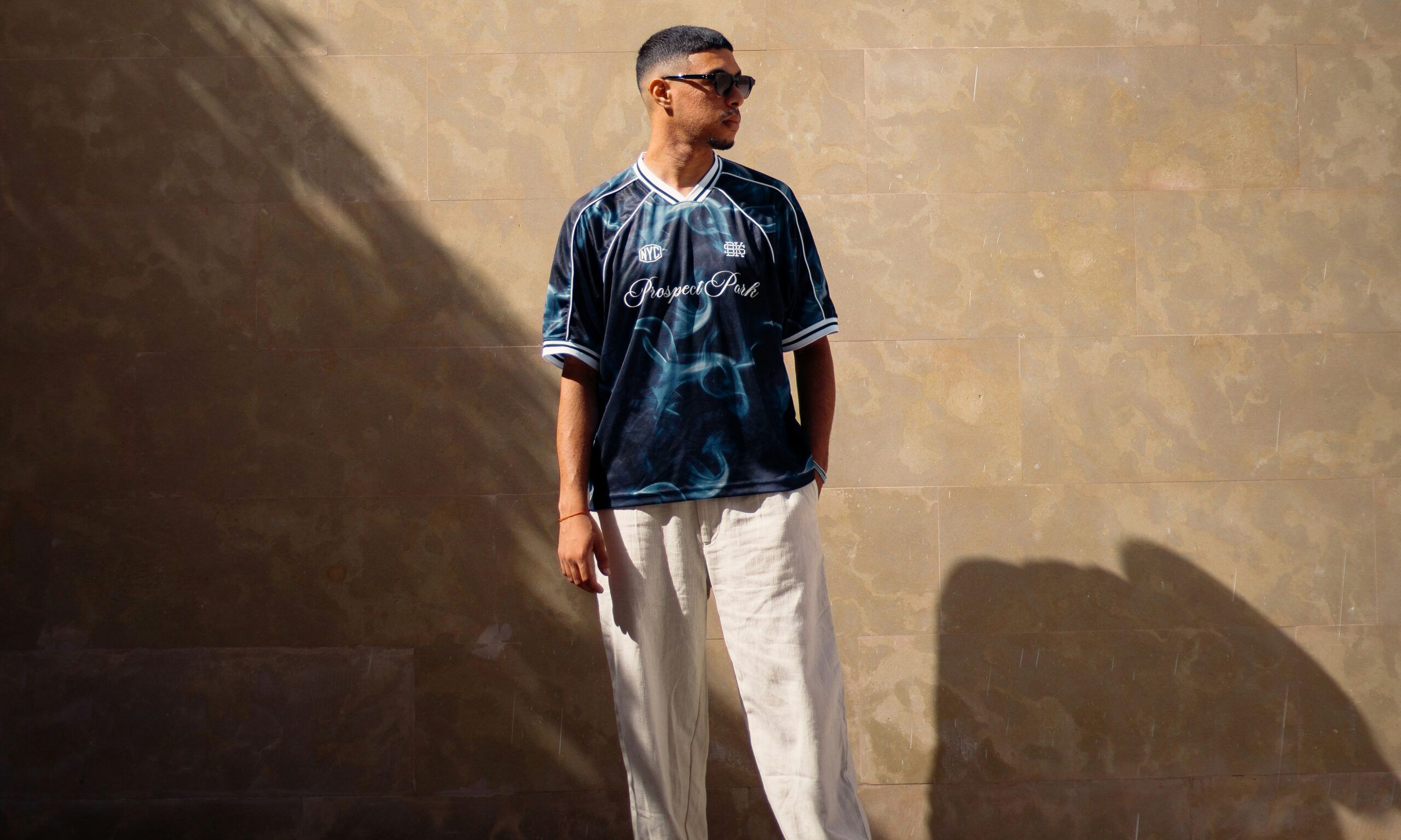 man in sunglasses standing in the sun