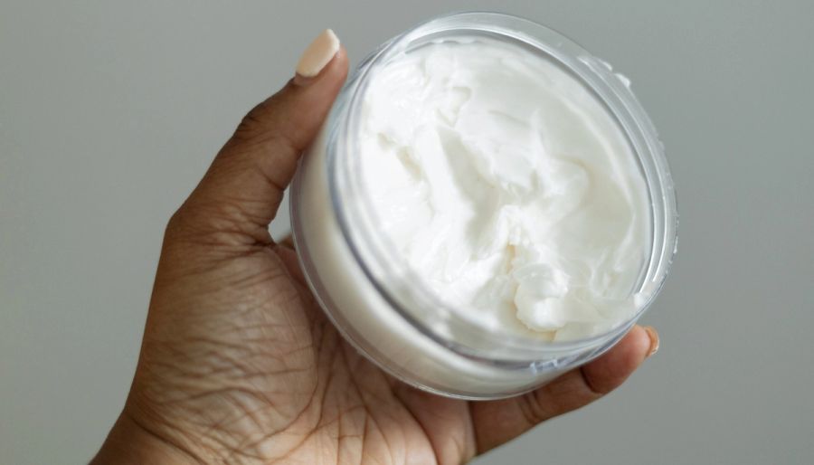 woman holding body lotion