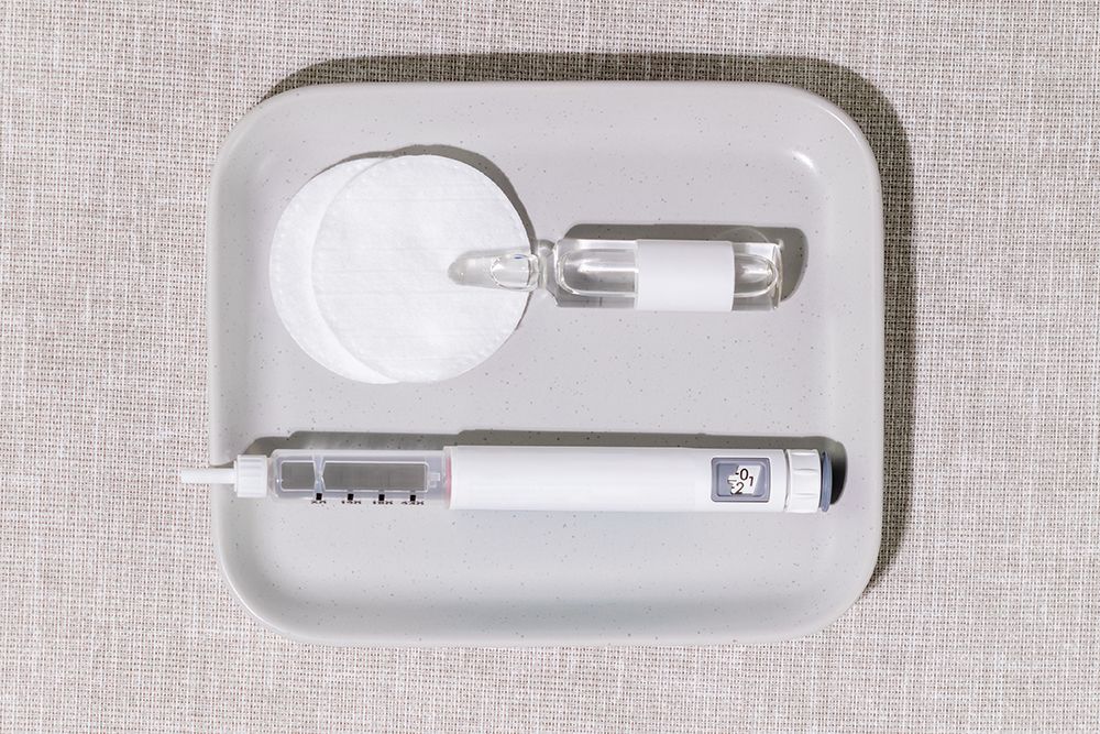 Medical Setup With Injection Pen, Glass Ampoule And Cotton Pads On Soft Fabric Background. Concept Of Home Beauty Treatments, Beauty Injection, Luxury Wellness Trends, And Skincare Innovation