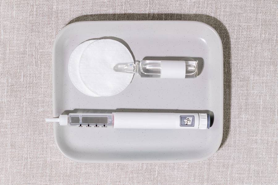 Medical Setup With Injection Pen, Glass Ampoule And Cotton Pads On Soft Fabric Background. Concept Of Home Beauty Treatments, Beauty Injection, Luxury Wellness Trends, And Skincare Innovation