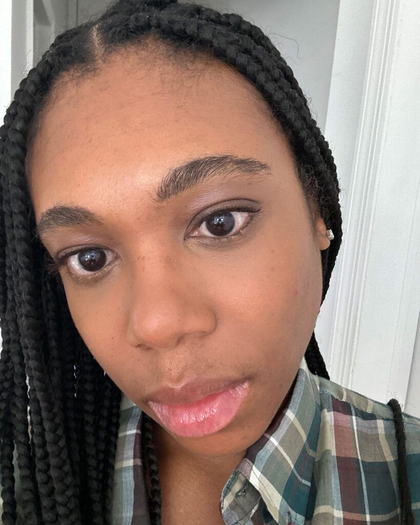 Woman showing off under-eye concealer