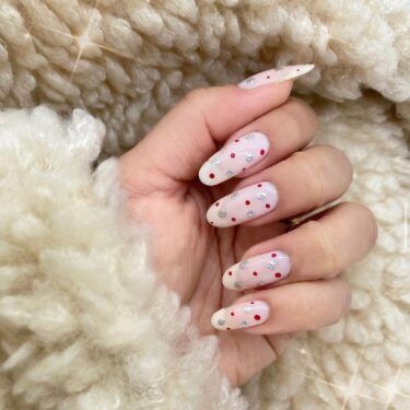 a close-up of oval nails with a polka dot design
