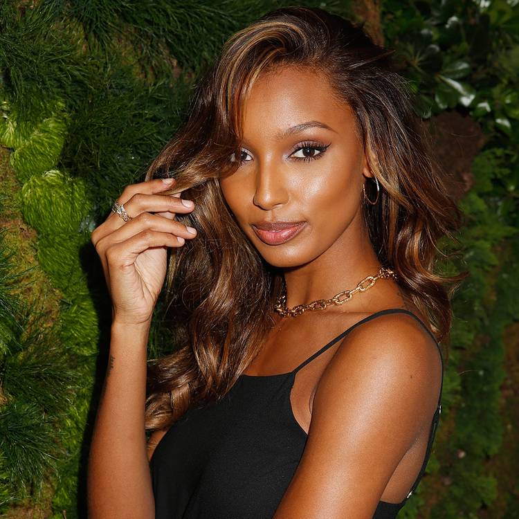 Photo of Jasmine Tookes touching hair
