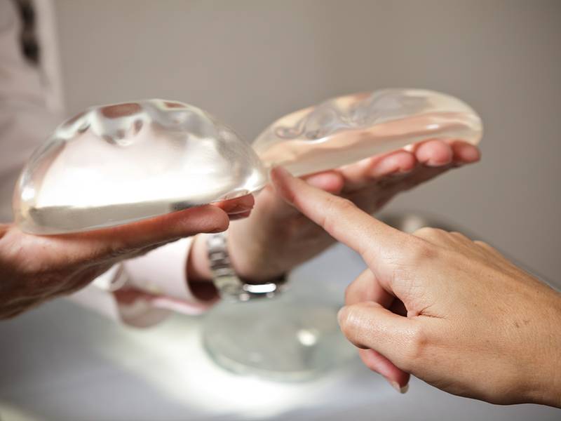 person choosing between breast implants