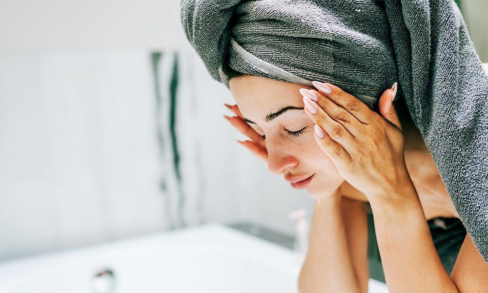 Woman washing her face