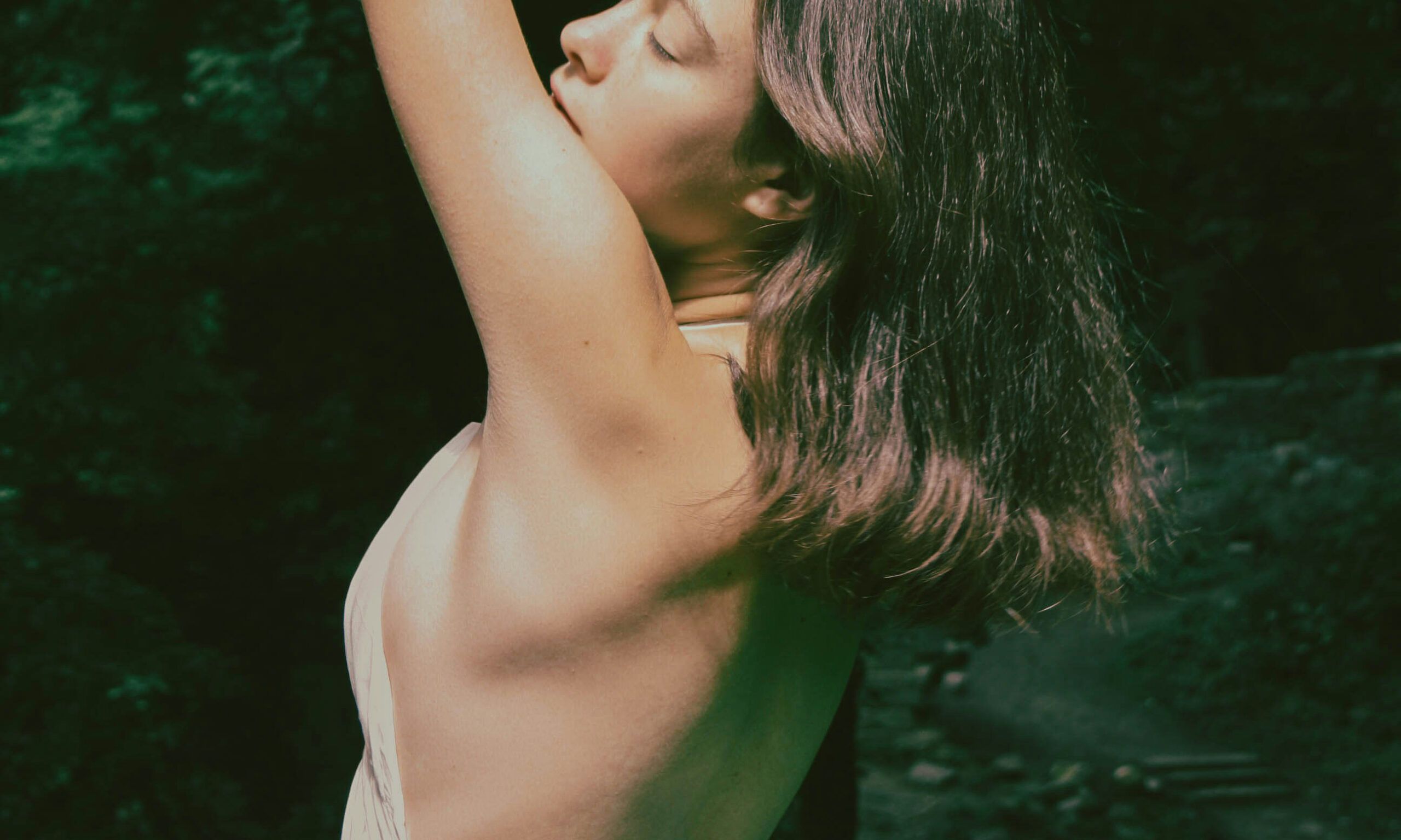 woman outdoors with arms up