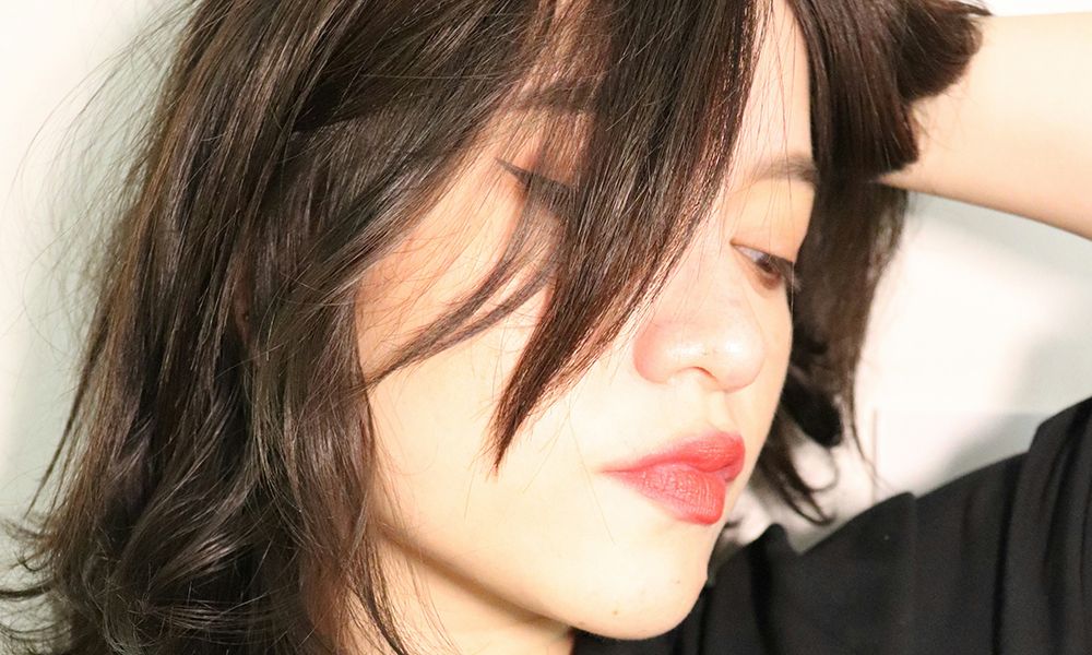 woman with brown hair and red lips