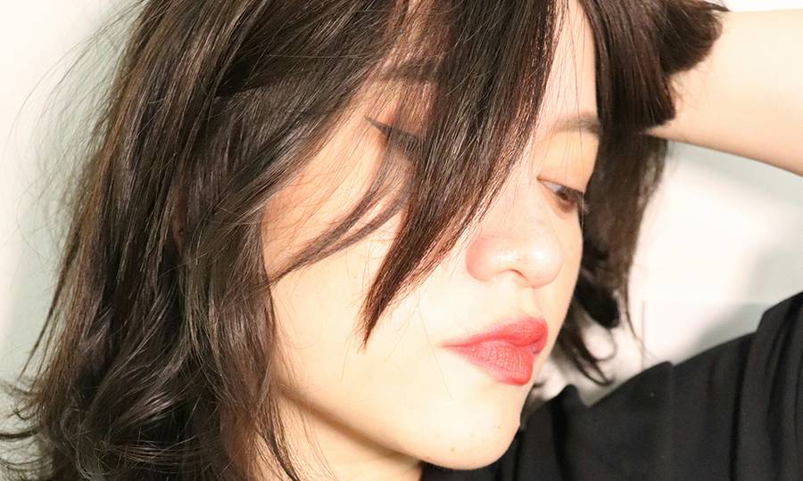 woman with brown hair and red lips