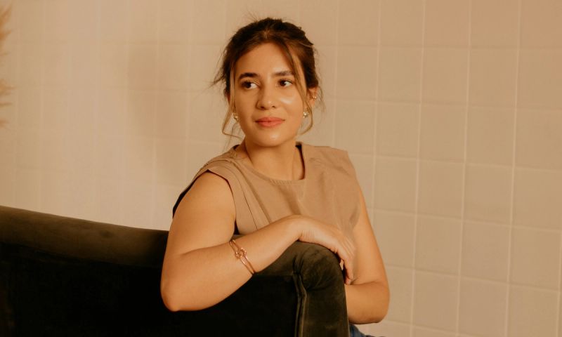 woman sitting on couch looking over her shoulder