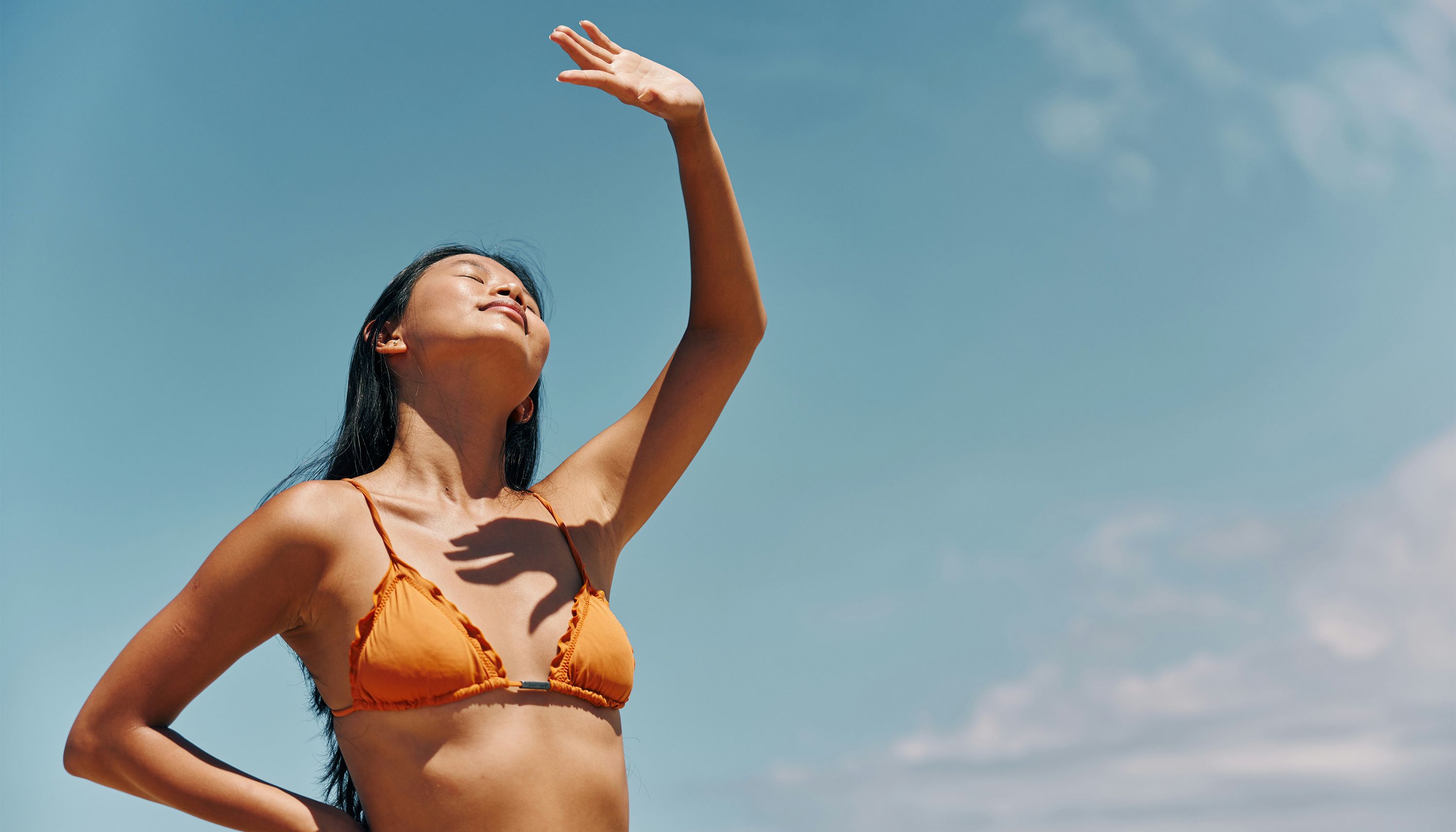 woman in a bathing suit blocking the sun