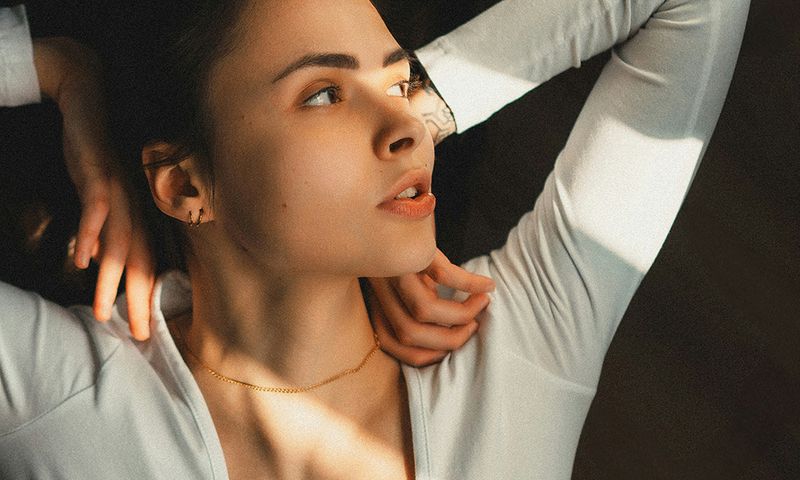 woman laying down with hands on shoulders