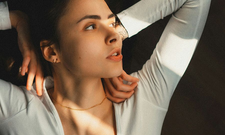 woman laying down with hands on shoulders