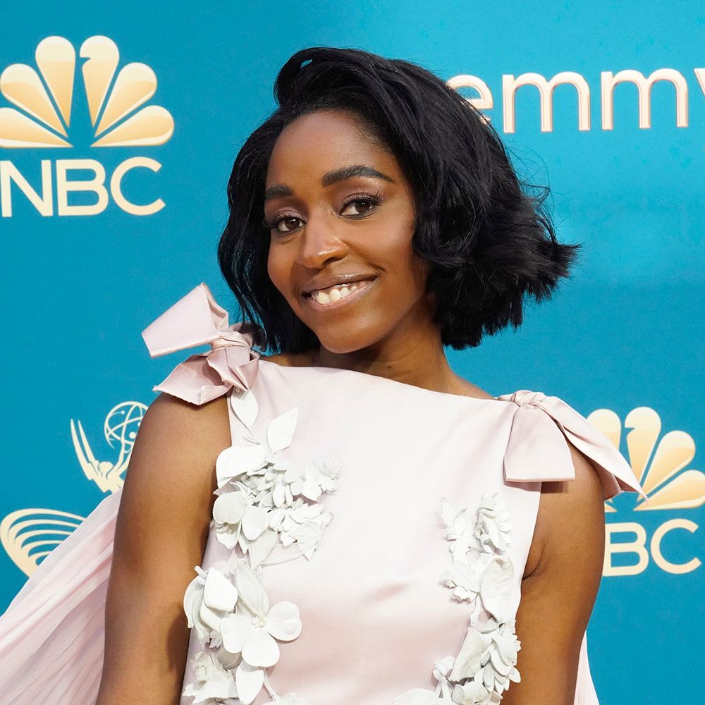Ayo Edebiri with a short bob and pale pink dress on the red carpet of the Emmy Awards
