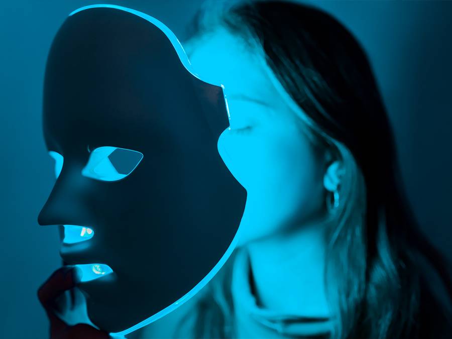 woman using blue light therapy mask