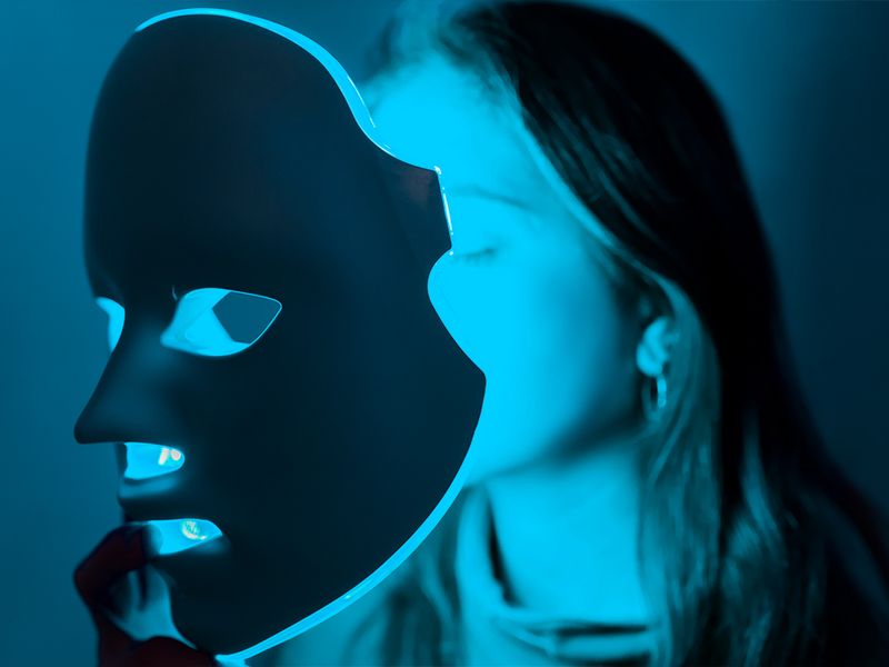 woman using blue light therapy mask