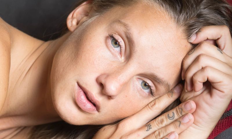 Bare-faced woman looking at camera