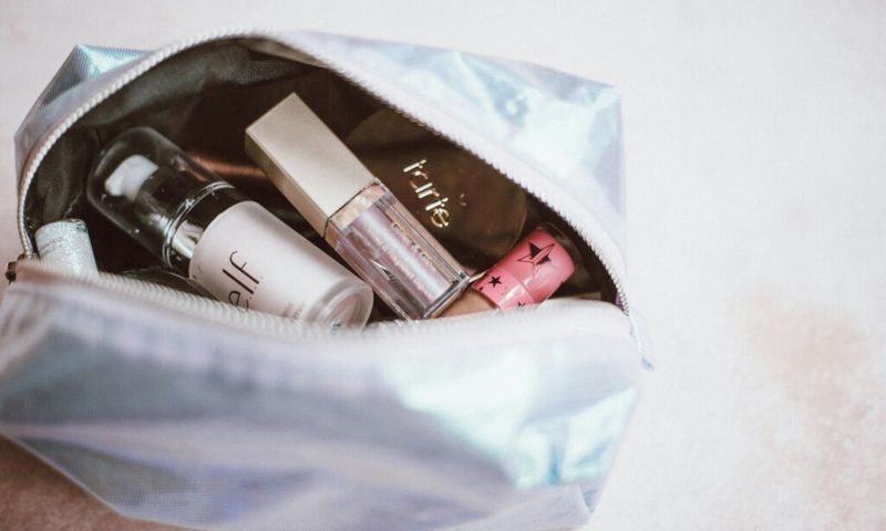 cosmetics bag open to show various makeup