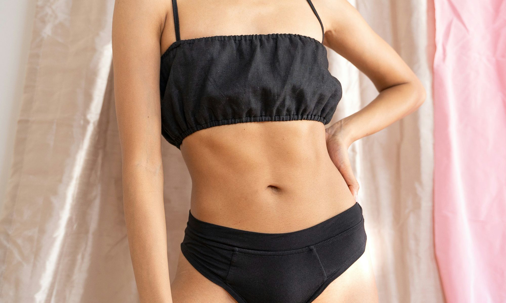 zoomed in of a woman's midsection, showing her chest, tummy and belly button