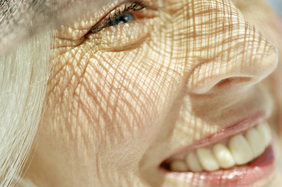 close up of mature's woman's face with sun shadows