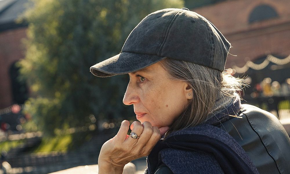older woman outdoors wearing a baseball cap