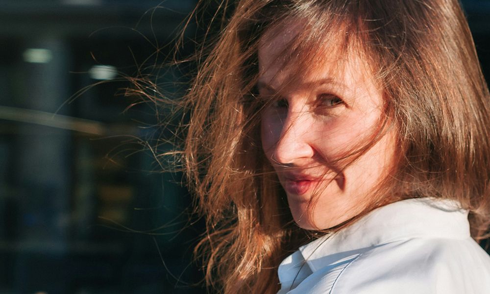 woman with wind swept hair in the sun