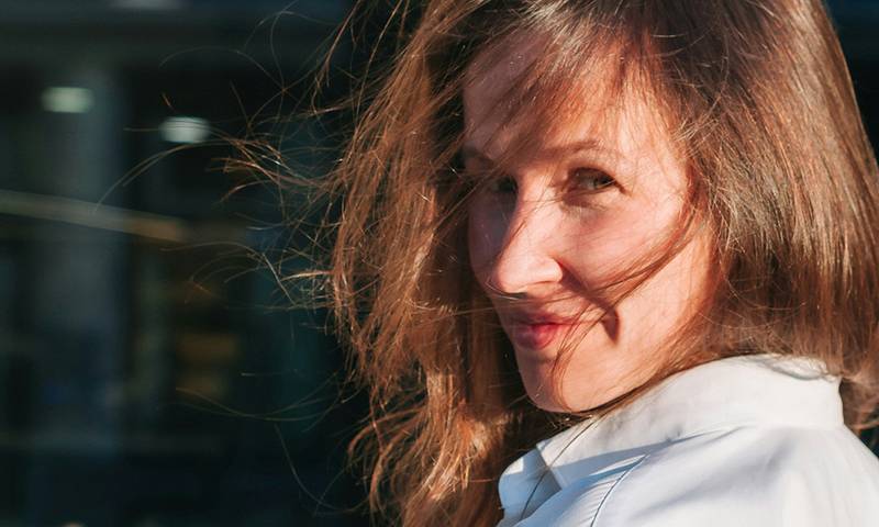 woman with wind swept hair in the sun