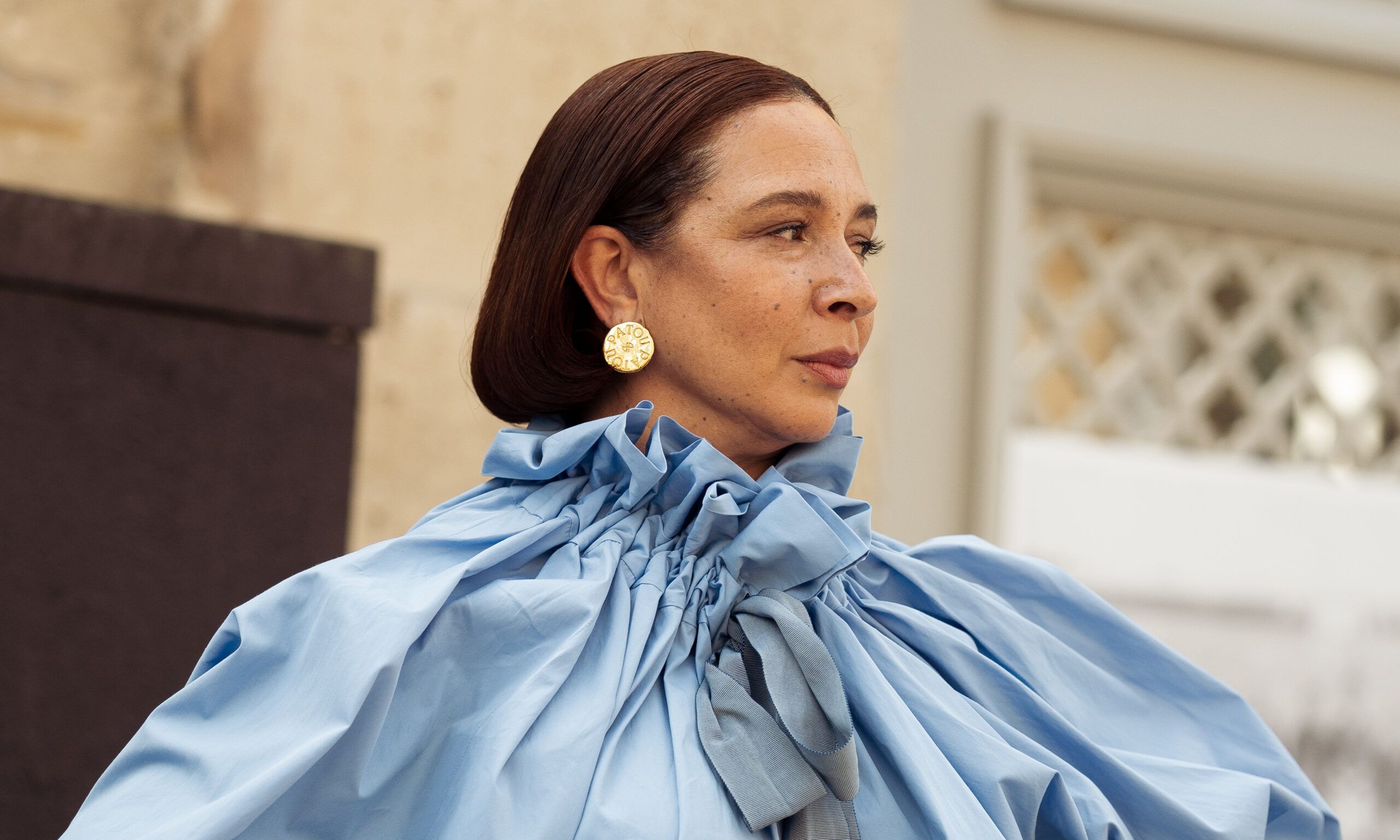 Maya Rudolph wears a long, light blue puffy sleeved dress outside
