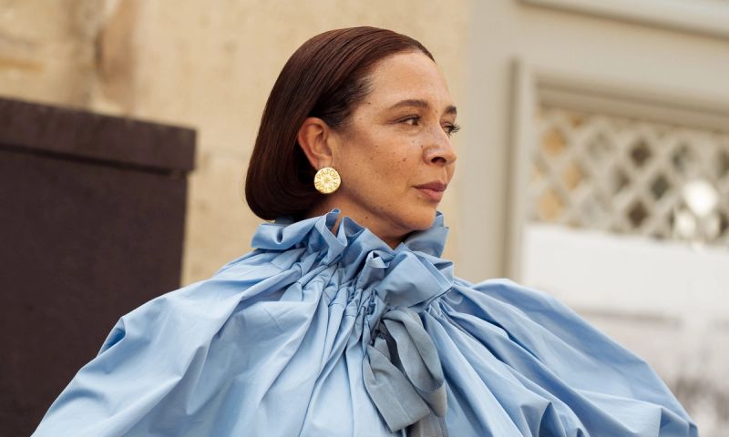 Maya Rudolph wears a long, light blue puffy sleeved dress outside