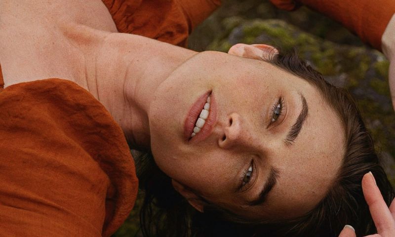 face portrait of woman laying on the ground