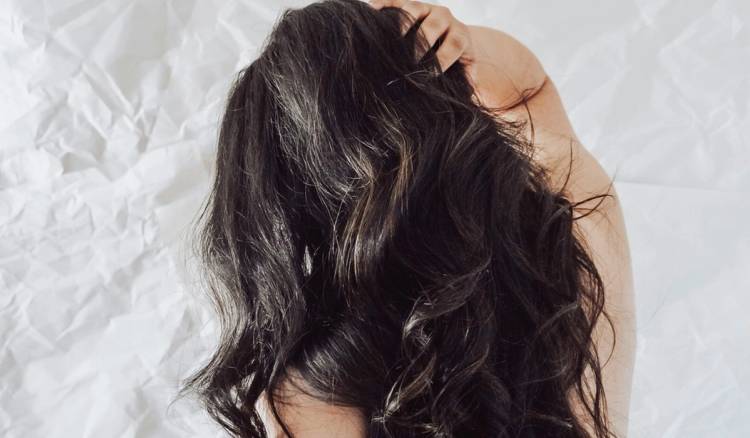 Overhead view of a person with long, wavy dark brown hair