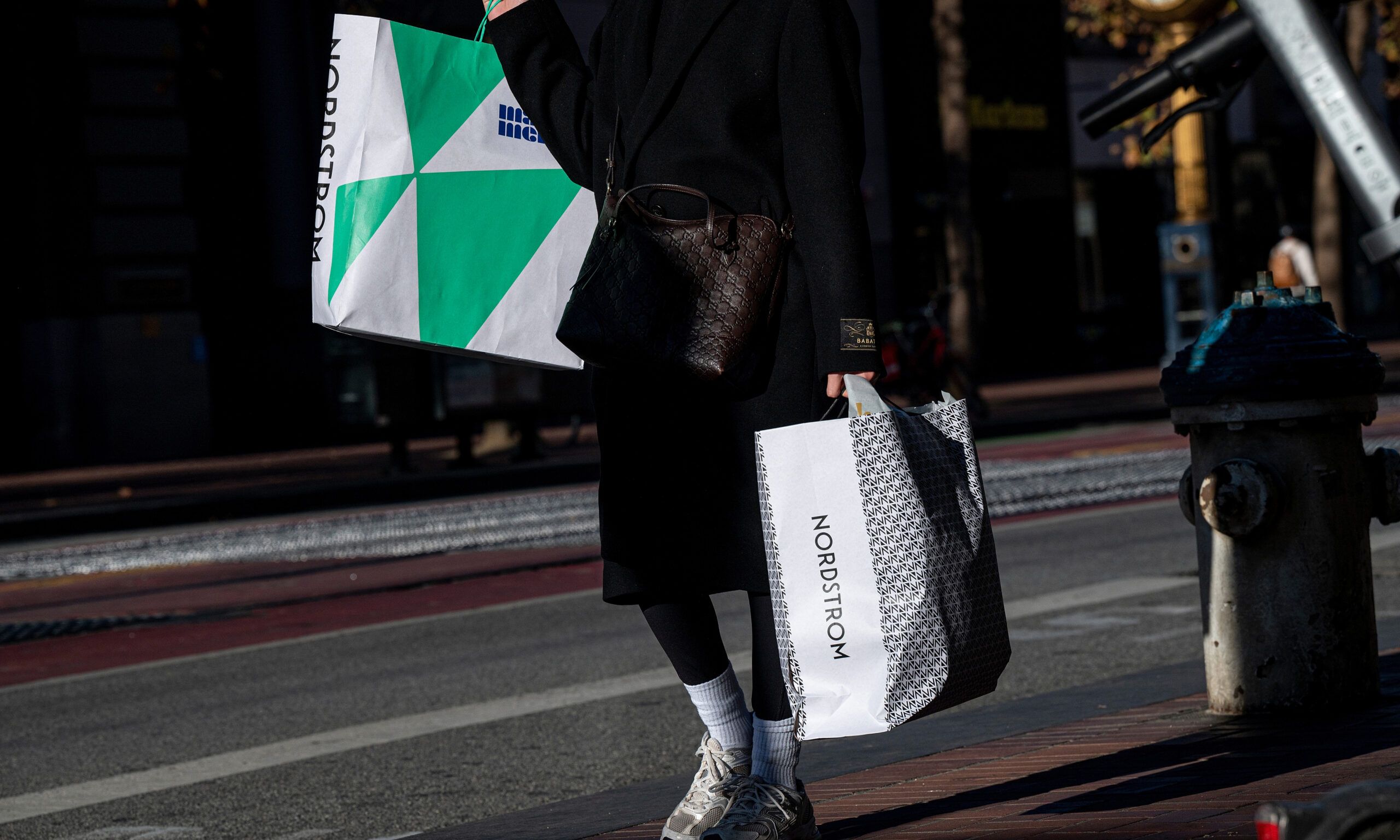 A shopper carries Nordstrom bags