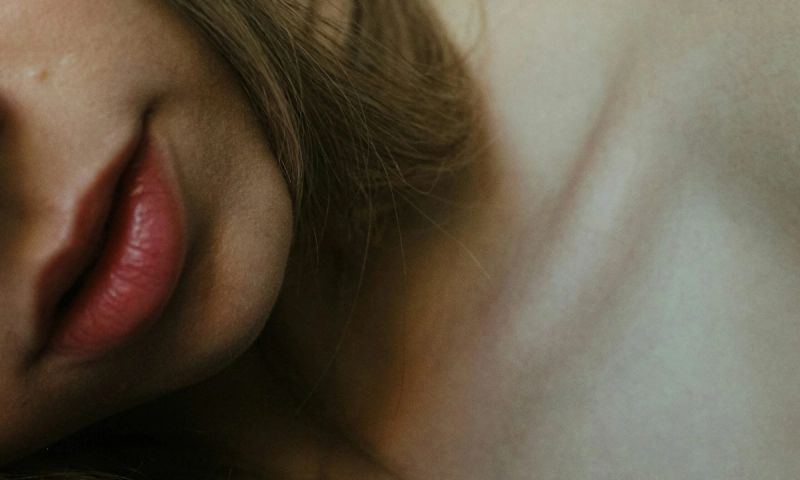 zoomed in image of woman's neck and chin area