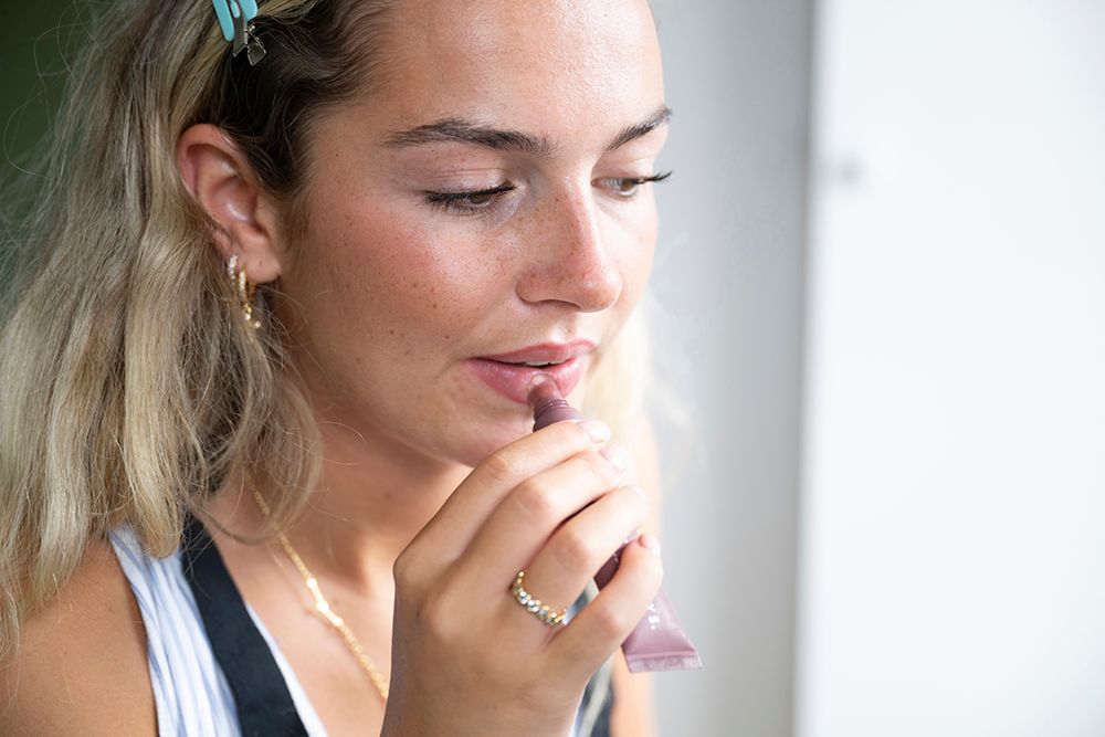 Headshot, psyche, portrait of a young white Caucasian women applying make up