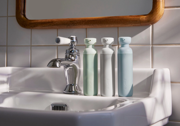 SURI's Restore Gel Refillable Toothpaste bottles in Meadow, Stone and Sky.