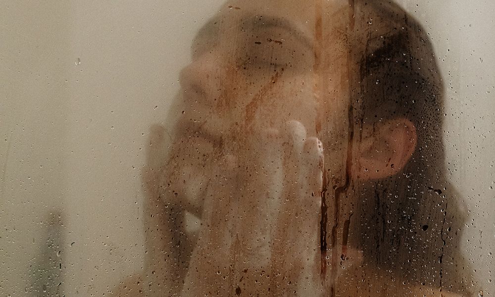 woman in shower washing face