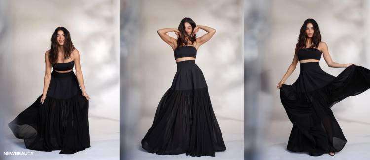 NewBeauty’s May digital cover star, Jenna Dewan, poses in a flowing black SIMKHAI two-piece look across three studio portraits, smiling, adjusting her hair and holding out the skirt.