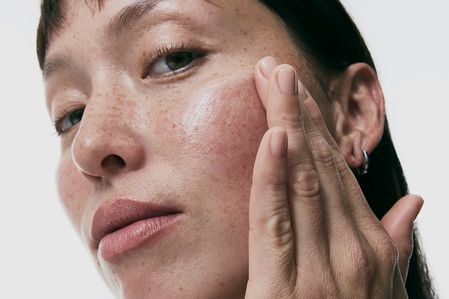 woman using vitamin c serum on face