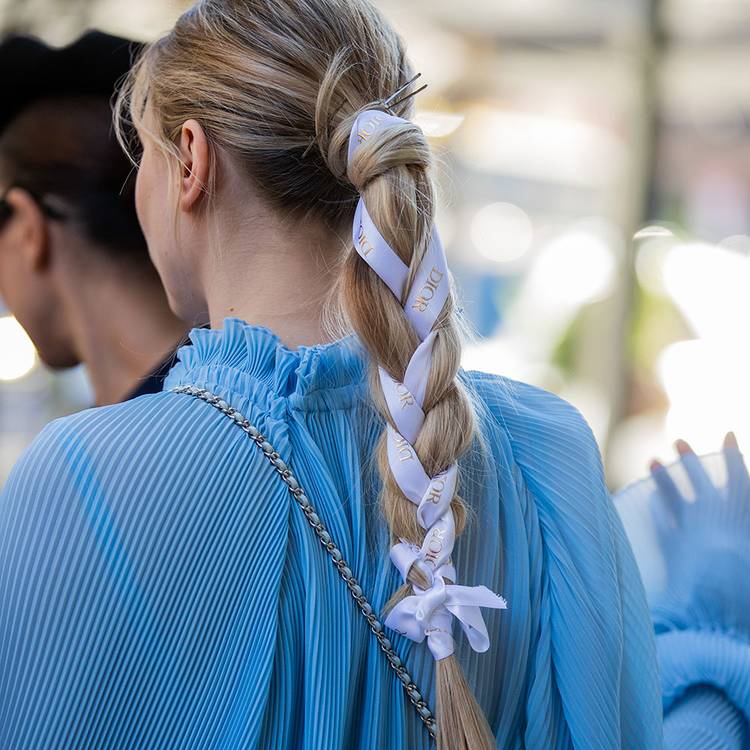 Back view of woman with braid ponytail with ribbons